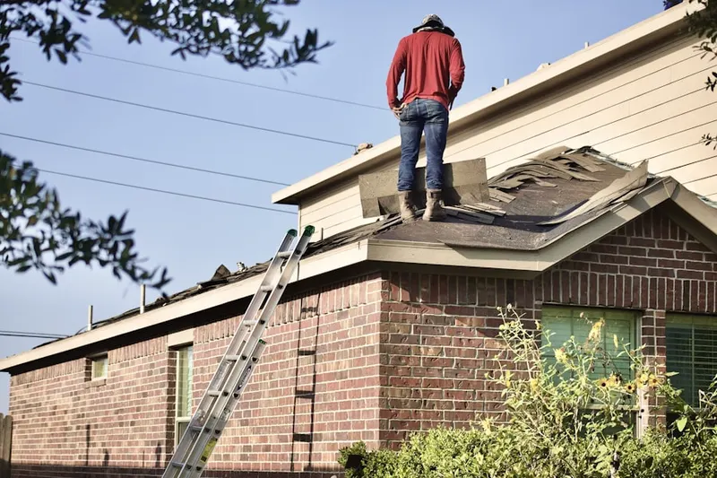 Professional roofer working on a residential roof in Nesbit